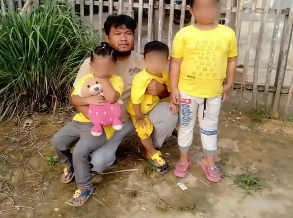 Ayah korban banjir di Sibolga berpose bersama tiga anaknya, sosok yang viral setelah mengaku nekat mengambil tiga bungkus mi instan demi memberi makan keluarga.