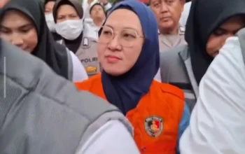 Eks Bupati Gowa Sitti Husniah Talenrang berompi oranye di antara petugas